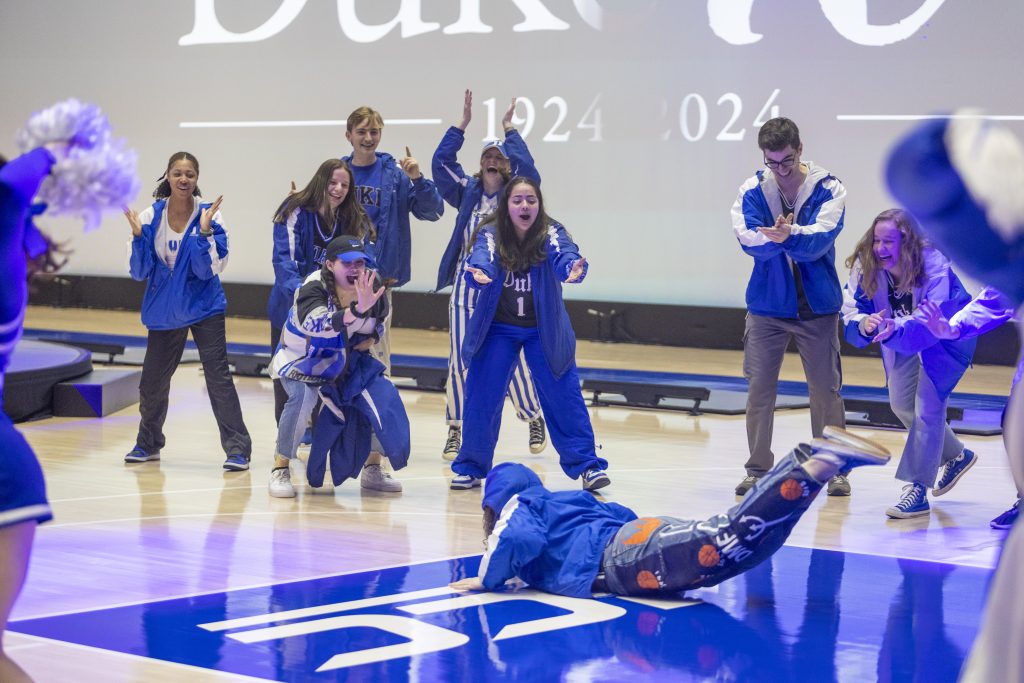 A student does the worm to pump on the floor at Cameron Indoor Stadium up the crowd at the beginning of the show