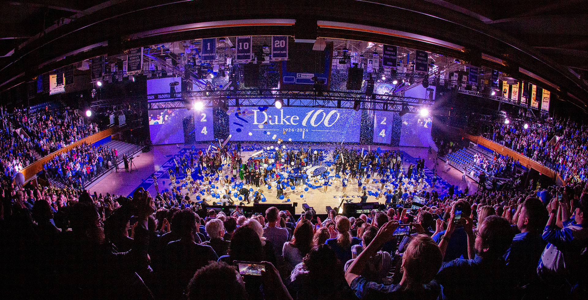 Every is on their feet in the stands as confetti rains down on the floor of Cameron Indoor Stadium