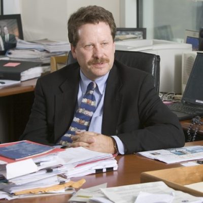 Robert Califf sitting at a desk cover with papers