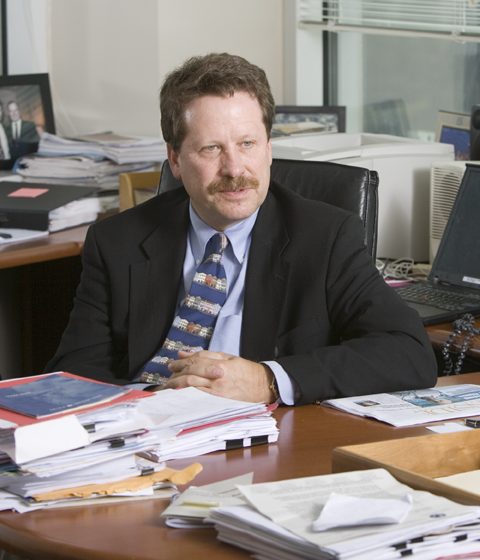 Robert Califf sitting at a desk cover with papers