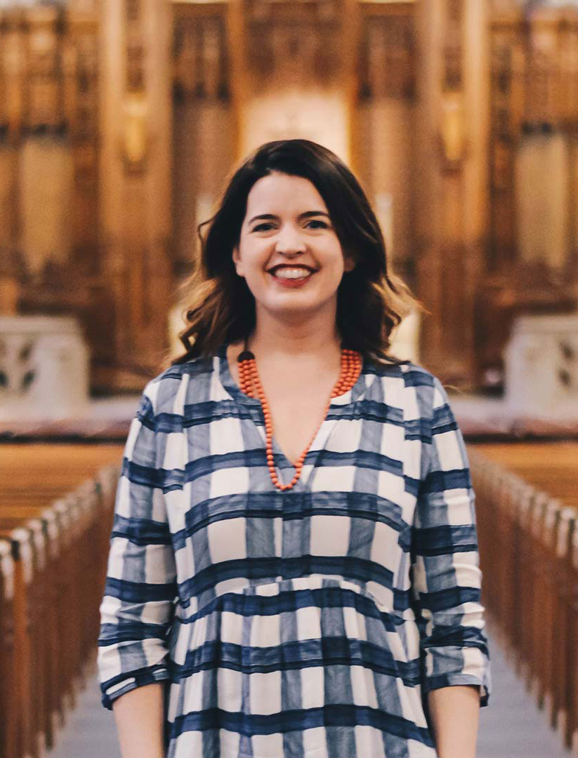 Kate Bowler standing in Duke Chapel with the organ in the background