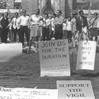 Historical photo of students with signs on the quad