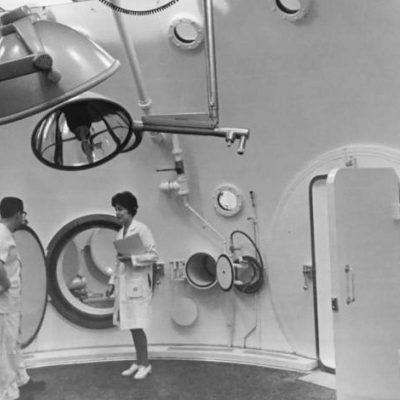 Two researchers standing in a hyberbaric chamber