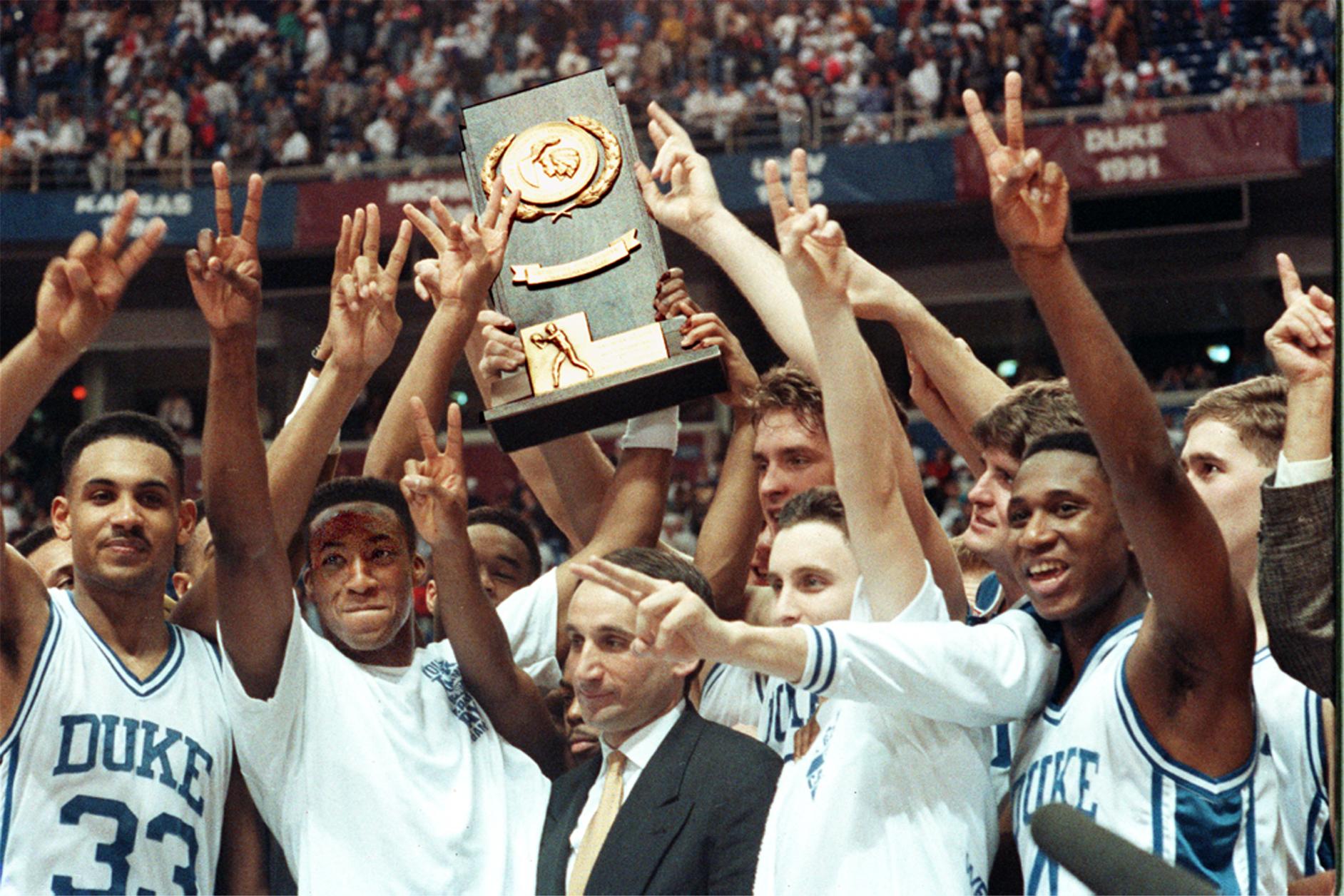 Coach K and the 1992 team holding up the NCAA title