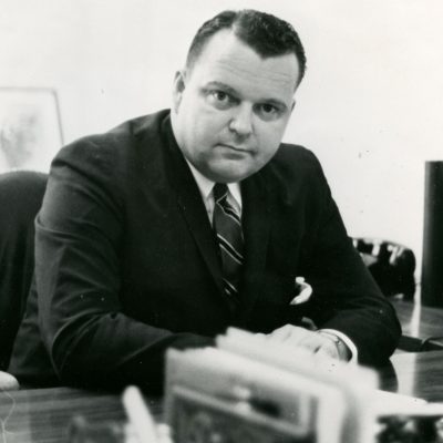 A. Kenneth Pye sitting at a desk