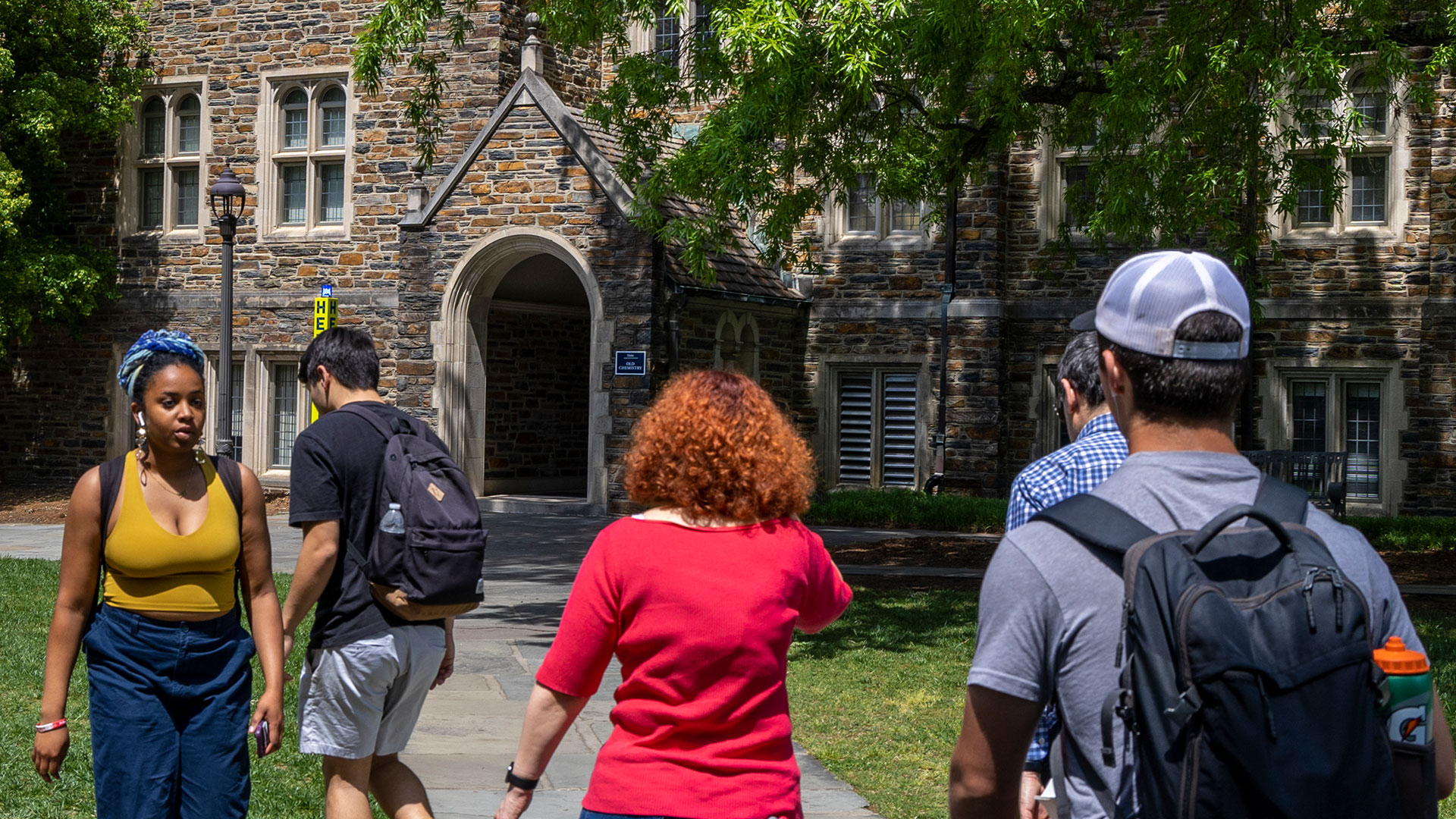 Students walk on paths across the quad outside the Old Chemistry building