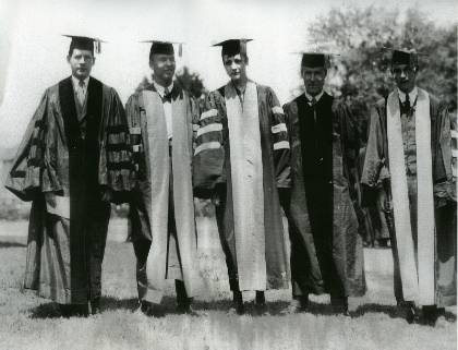 A black and white photo of PhD graduates in robes
