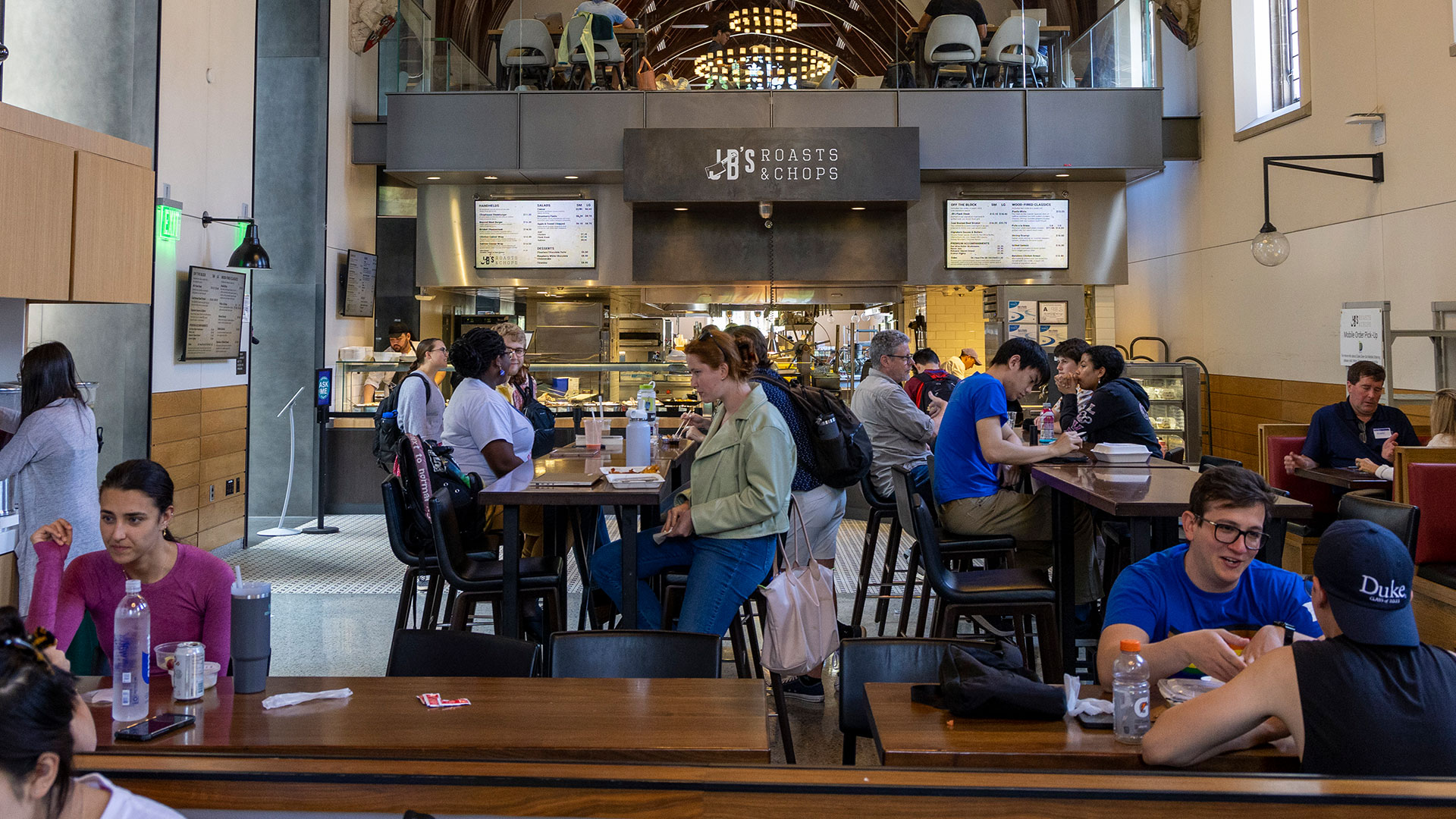 A recent photo of the Great Hall with people at tables and a restaurant in the middle