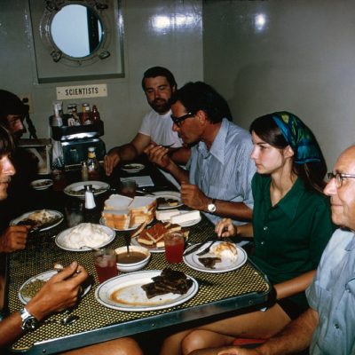 John Newton and team eating a meal on the ship in 1973