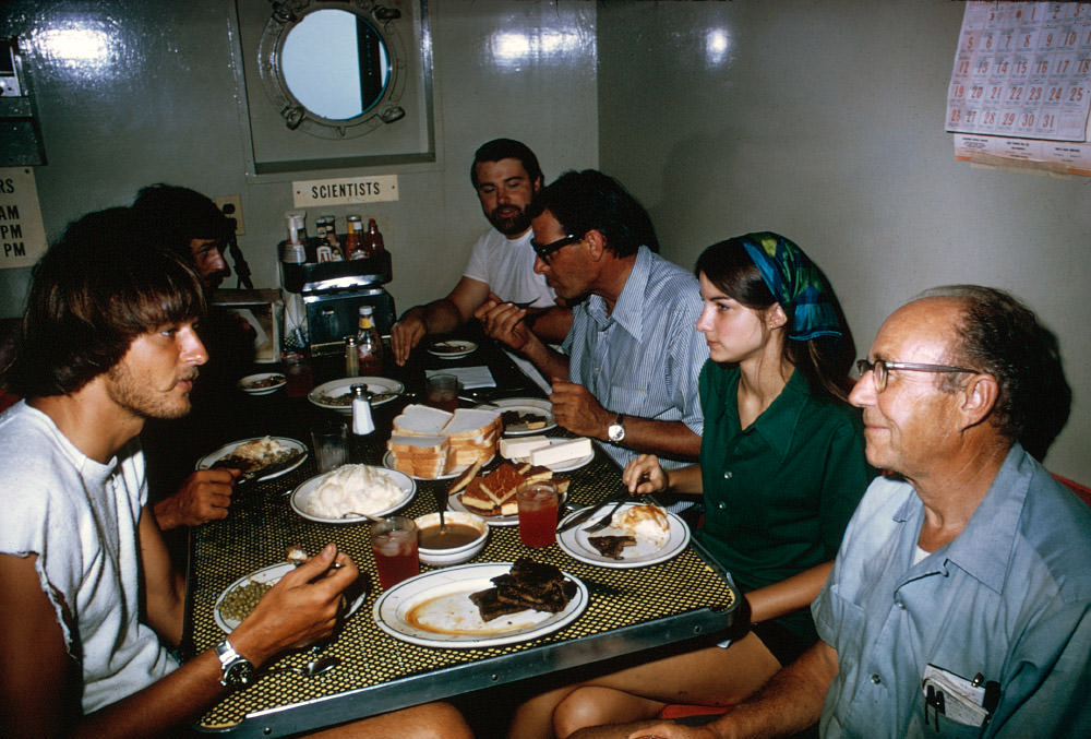 John Newton and team eating a meal on the ship in 1973