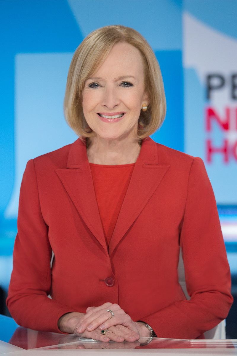 Judy Woodruff headshot on set of PBS New Hour