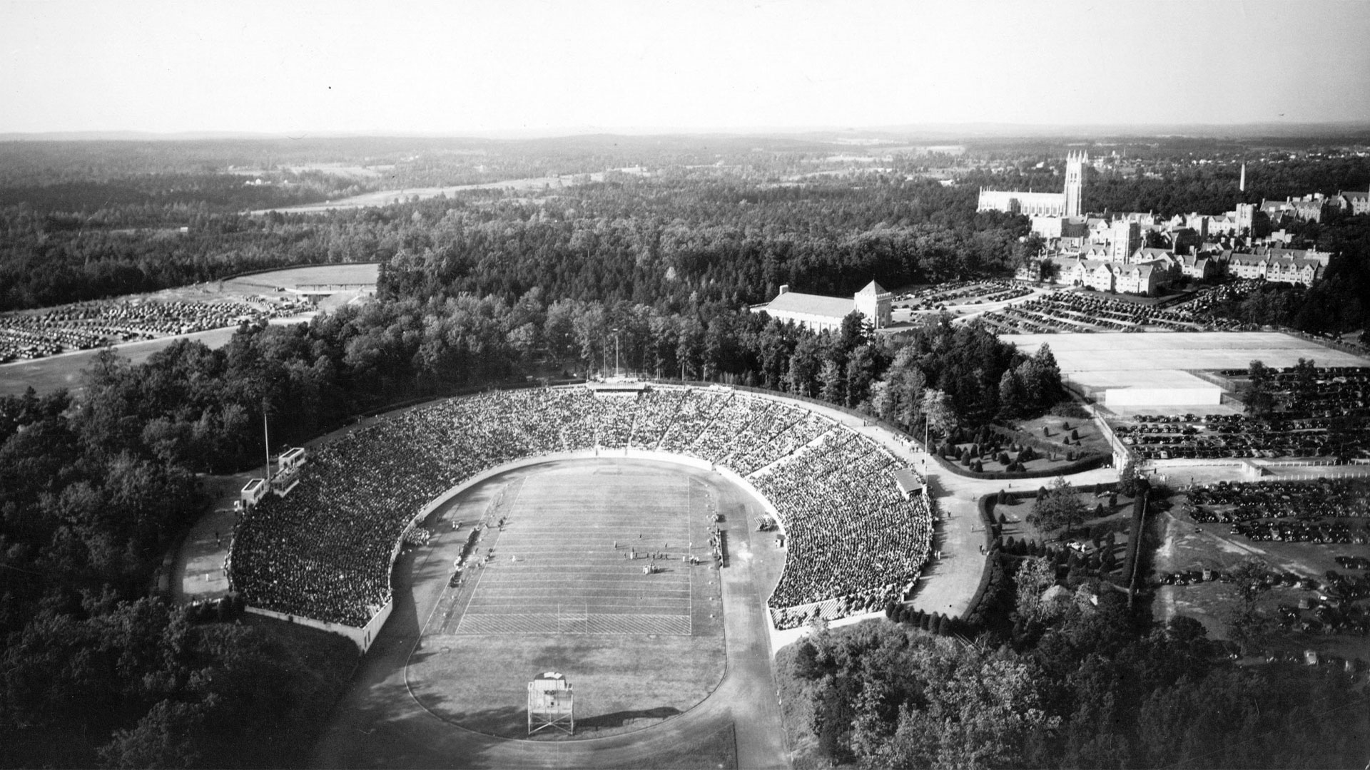 A historic photo of Wallace Wade Stadium surrounded by large parking lots