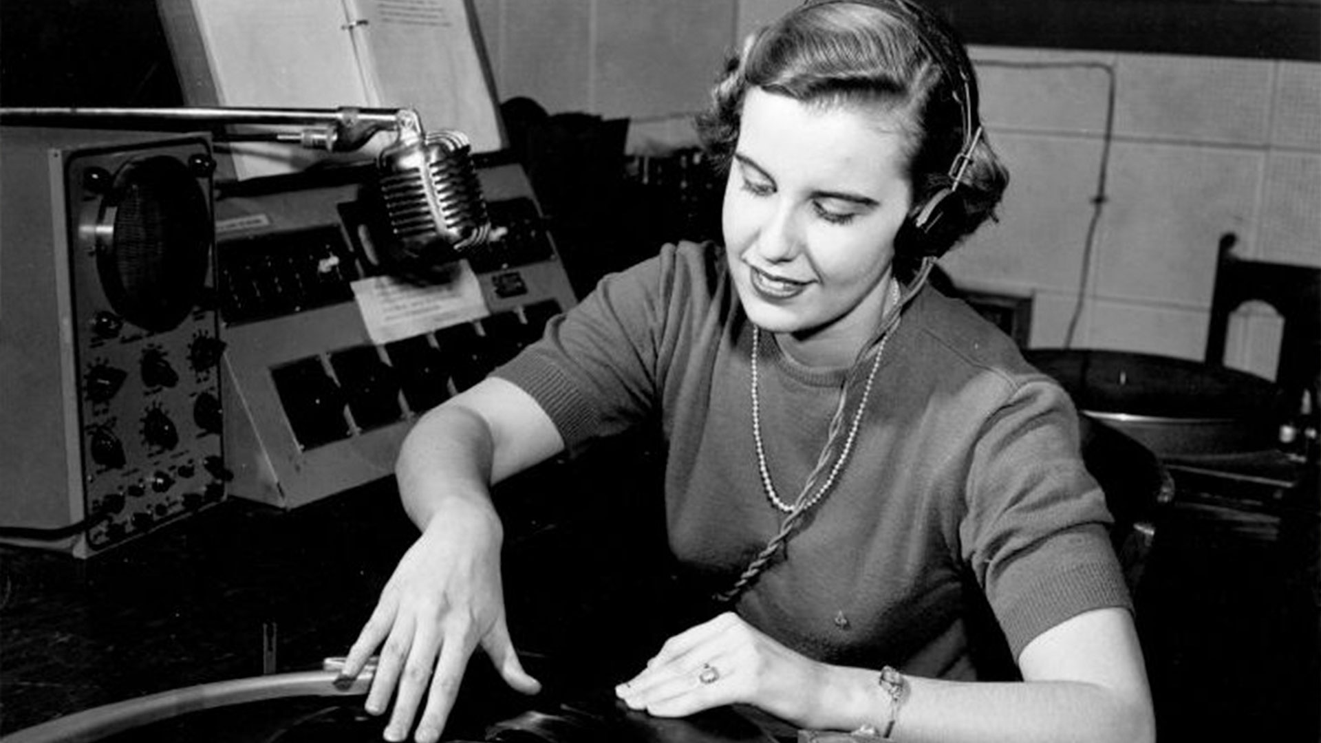 A student playing a record on the radio in 1950